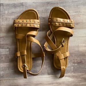 Tan sandals with gold embellishments